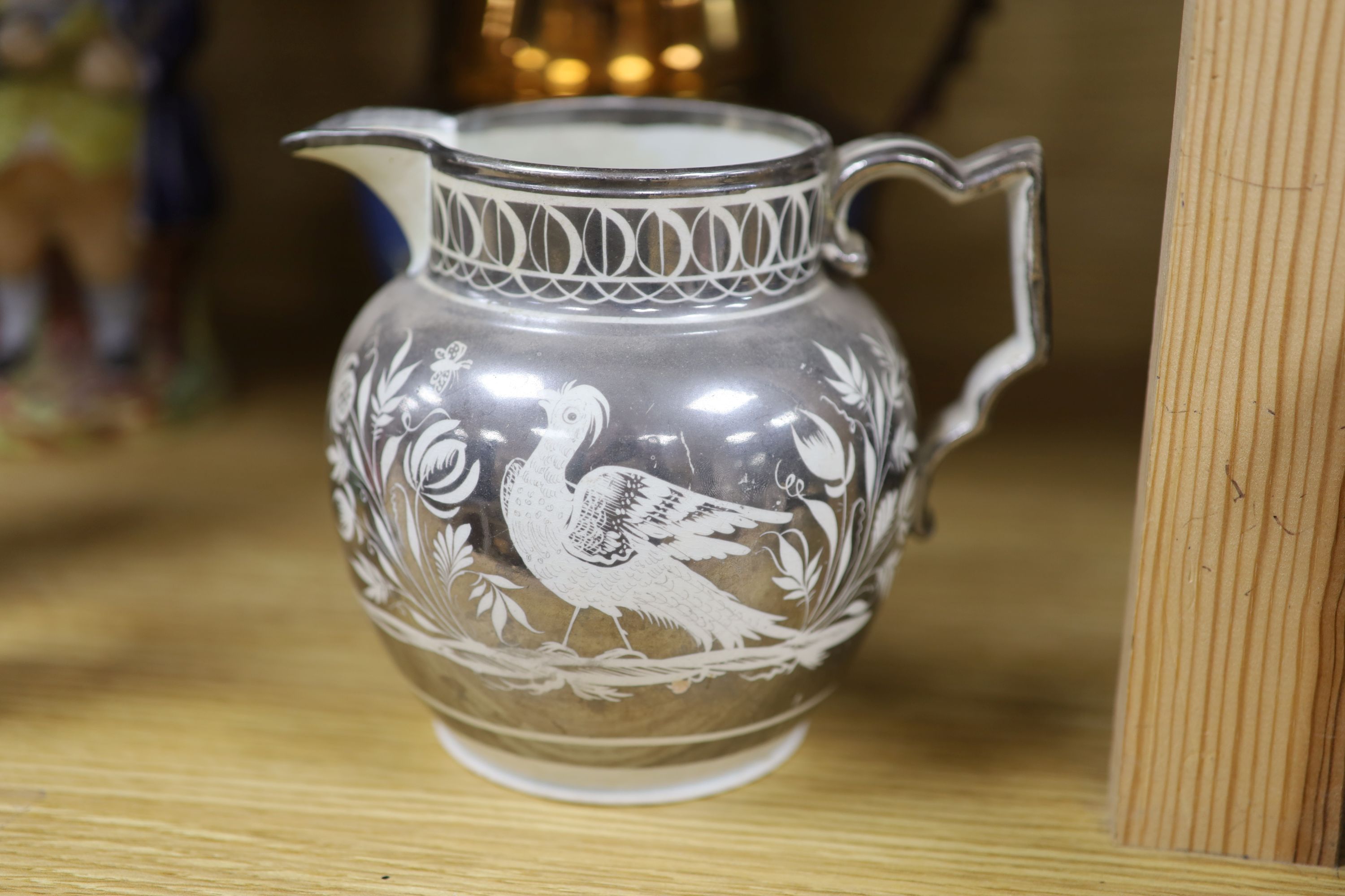 A quantity of Staffordshire pottery, including four Toby jugs, four figures, a copper lustre jug and a silver resist jug (10)